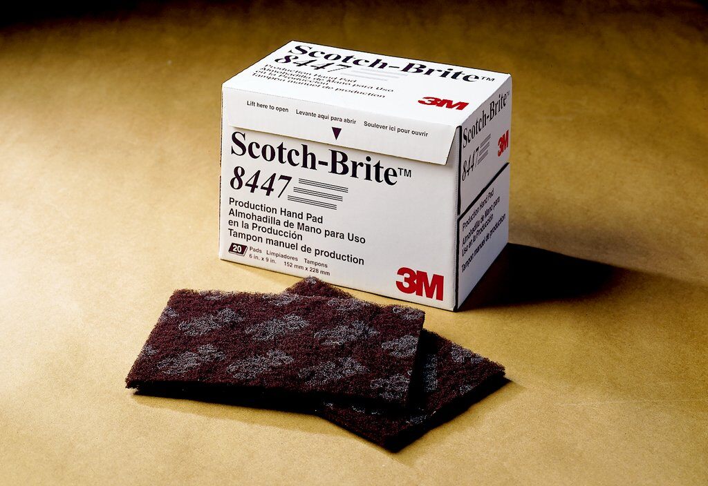 3M Scotch-Brite SB12260 non-woven pads, 6x9 inches, used for cleaning and surface preparation in industrial or workshop settings.