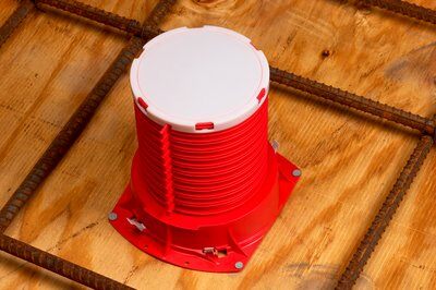 3M 3PCID fire barrier cast-in device for 3-inch plastic pipes, showing the installed fire-resistant cast-in device in a construction setting.