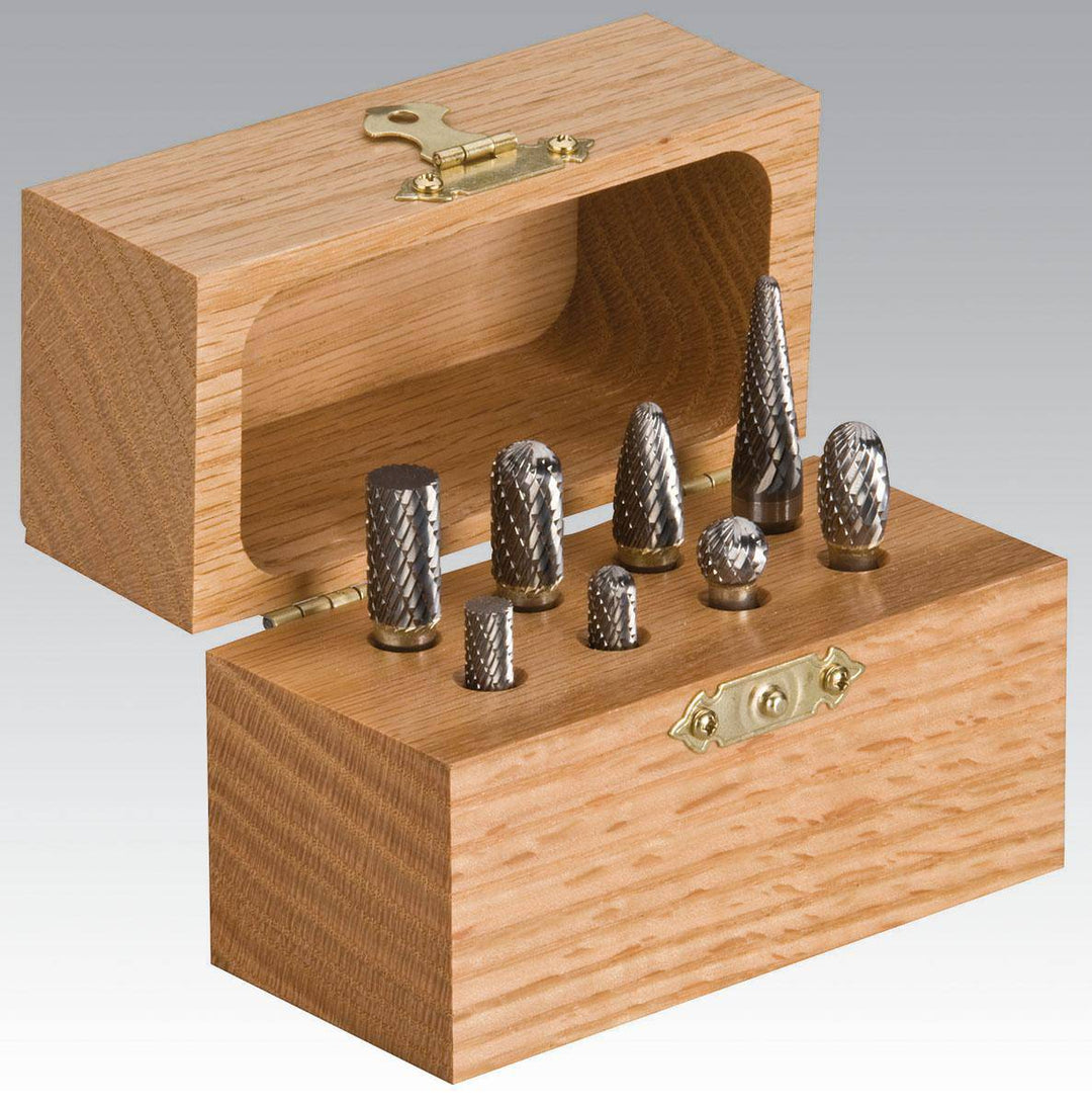 Dynabrade 93350 8-piece carbide burr kit with 1/4 inch shaft for metal grinding and shaping, includes various burr types.