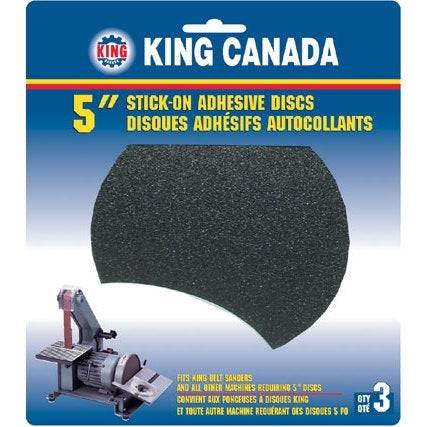 King Canada 5-inch PSA adhesive discs in 120 grit, displayed on a surface with some stacked for use in sanding and polishing tasks.