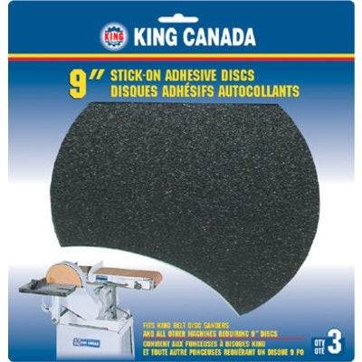 King Canada SD-9-K-120 9-inch self-adhesive PSA discs in 120 grit, showing a stack of gray abrasive discs with backing paper